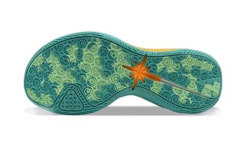 Bottom view of a teal and green sports shoe sole with decorative pattern and an orange star accent