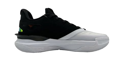Black and white basketball shoe with cushioned sole and neon green accent detail on side